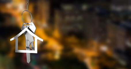 Poster - Image of hanging silver house keys against blurred view of night cityscape with copy space