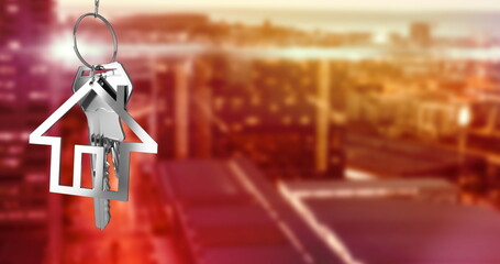 Poster - Image of hanging silver house keys against blurred view of cityscape with copy space