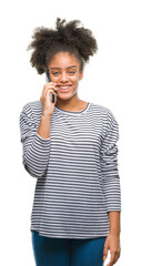 Canvas Print - Young afro american woman talking on the phone over isolated background with a happy face standing and smiling with a confident smile showing teeth