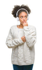 Poster - Young afro american woman wearing headphones over isolated background serious face thinking about question, very confused idea