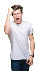 Sticker - Young handsome man wearing casual white t-shirt over isolated background angry and mad raising fist frustrated and furious while shouting with anger. Rage and aggressive concept.