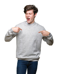 Wall Mural - Young handsome sporty man wearing sweatshirt over isolated background looking confident with smile on face, pointing oneself with fingers proud and happy.