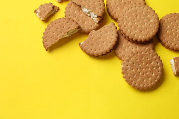 Wall Mural - Tasty sandwich cookies on yellow background, top view. Space for text