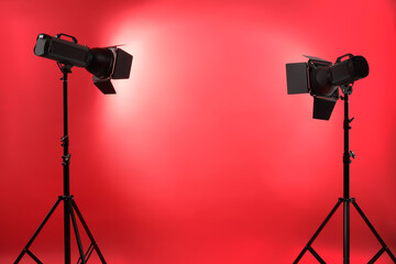 Wall Mural - Red photo background and professional lighting equipment in studio