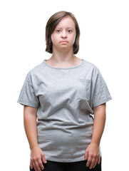 Wall Mural - Young adult woman with down syndrome over isolated background with serious expression on face. Simple and natural looking at the camera.