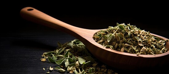 Aufkleber - A top-down view of dried oregano herbs in a wooden spoon against a black background with a close-up shot and selective focus, offering ample copy space in the image.