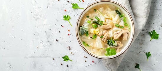 Poster - A white table with a glossy surface displays a bowl of cabbage and shiitake mushroom soup, with ample copy space image.