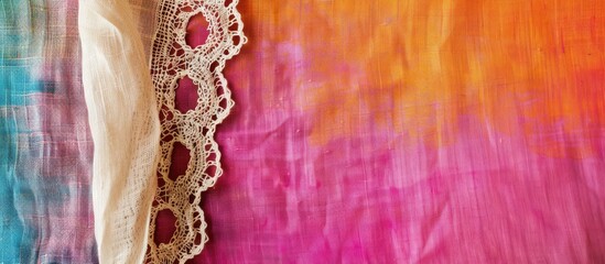 Fototapete - Natural linen with lace ribbon against a vibrant cloth backdrop, creating a border frame for a copy space image.