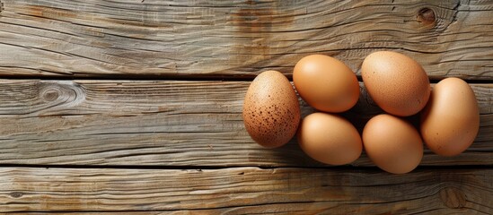 Poster - Three eggs displayed on a rustic wooden table with copy space image.