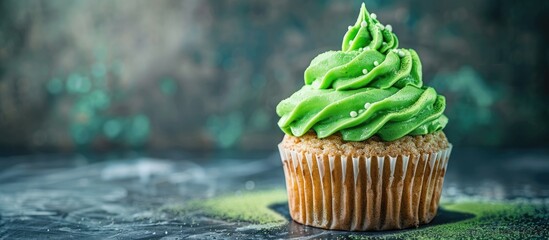 Sticker - A delectable green cupcake in a well-lit studio setting with ample copy space image.