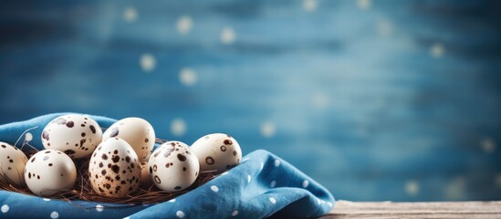 Poster - Rustic Easter theme with quail eggs on a blue fabric, offering ample copy space image.