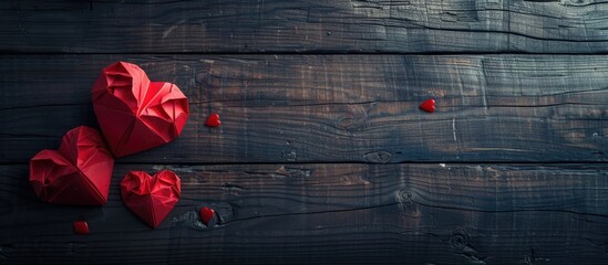 Poster - Valentine's Day themed composition featuring two red paper hearts displayed on a dark wooden surface, with ample copy space image available.