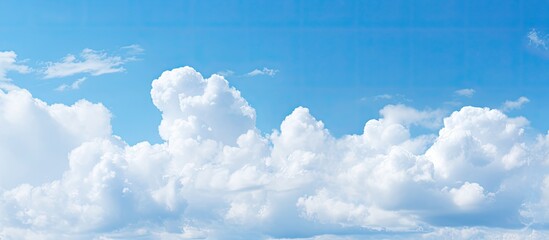 Poster - Soft-focused white clouds against a blue sky background with copy space image.