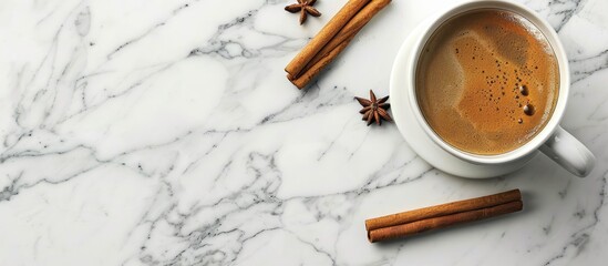 Aufkleber - Top view of a cup with coffee and cinnamon sticks on a marble surface providing copy space image.