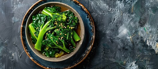 Sticker - Chinese dish featuring boiled leafy greens drizzled with oyster sauce, with copy space image.