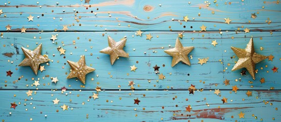 Poster - Top view of golden star Christmas banners on light blue and wooden azure backgrounds with a grid, perfect for a copy space image.