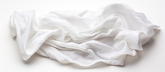 Wall Mural - White background with crumpled fabric napkin, providing a copy space image.