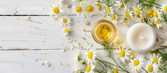 Sticker - Chamomile flower beauty product samples displayed on a white wooden table with copy space image.