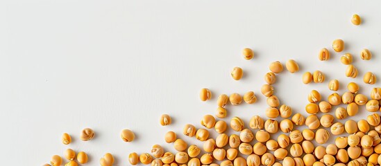Poster - Top view of uncooked yellow peas arranged along a border on a white background, providing ample copy space image.