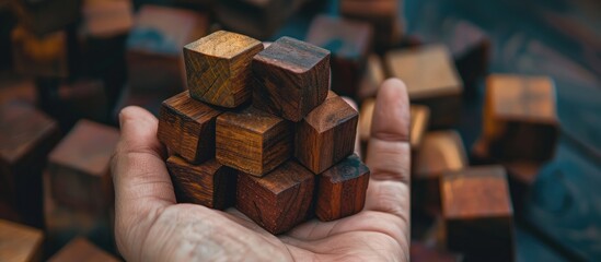 Poster - A hand holding wooden cubes with room for text in a copy space image.