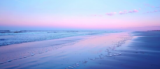 Poster - Seascape with a serene beach at sunset. The horizon filled with a blend of blue and pink hues, creating a tranquil setting for the copy space image.