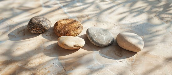Poster - Granite stones arranged on a beige surface with shadows, suitable for copy space image.