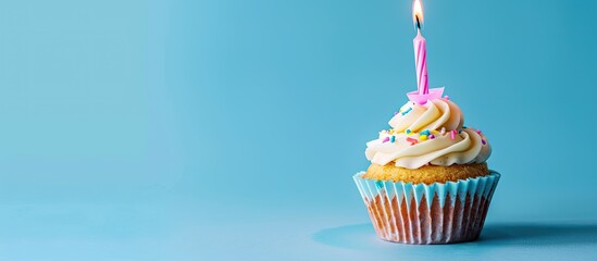 Aufkleber - A birthday cupcake with pink candles against a blue backdrop, ideal for adding text or graphics with copy space image.