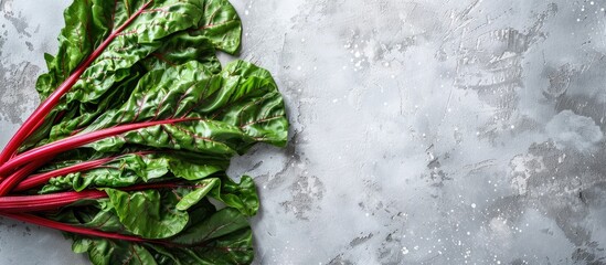 Poster - Top view of healthy and highly nutritious raw chard leaves on a light background with copy space image.