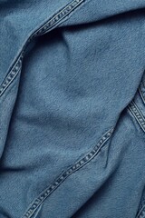 Aufkleber - Blue jeans close-up on wrinkled folded fabric with slight sheen. Denim texture and folds in focus against blurred background. Perfect for fashion, textile, or lifestyle photography.