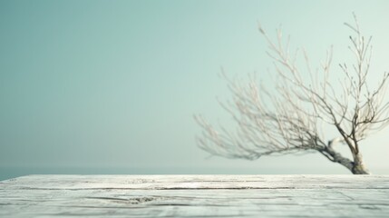 Wall Mural - A tree is standing on a wooden platform with a blue sky in the background