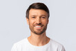 © Prostock-studio - Portrait Of Cheerful Man Smiling At Camera Over White Background In Studio. Isolated