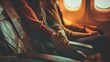 © liliyabatyrova - A man and a woman hold hands while sitting next to each other on an airplane