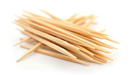 Poster - A stack of wooden toothpicks arranged on a white surface, ideal for use as props or decorative elements
