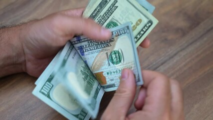 Poster - Legal firm managing partner carefully counts dollar banknotes received as part of retainer fee allocating funds to cover ongoing case expenses and firm overheads