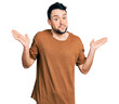 © Krakenimages.com - Hispanic man with beard wearing casual t shirt clueless and confused with open arms, no idea and doubtful face.