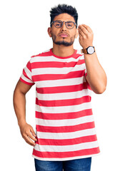 Poster - Handsome latin american young man wearing casual clothes and glasses doing italian gesture with hand and fingers confident expression