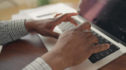Unrecognizable internet user surfing websites, close-up view of black man hands. IT specialist, programmer or hacker using laptop, typing text on keyboard, programming and coding, freelancer with PC
