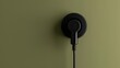 © QAISAR - The black plug is plugged into the power lines on olive background