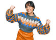 © Krakenimages.com - Young hispanic woman wearing casual clothes screaming proud, celebrating victory and success very excited with raised arms