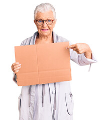 Wall Mural - Senior beautiful woman with blue eyes and grey hair holding we need a change banner smiling happy pointing with hand and finger