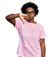 Sticker - African american woman with afro hair wearing casual clothes and glasses looking unhappy and angry showing rejection and negative with thumbs down gesture. bad expression.