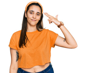 Wall Mural - Young hispanic woman wearing casual clothes shooting and killing oneself pointing hand and fingers to head like gun, suicide gesture.