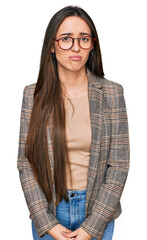 Canvas Print - Young hispanic girl wearing business clothes and glasses depressed and worry for distress, crying angry and afraid. sad expression.