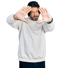 Wall Mural - Middle age caucasian man wearing casual clothes doing frame using hands palms and fingers, camera perspective