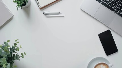 Wall Mural - Top view of office essentials including a notepad laptop coffee cup mouse pad and mobile phone with a blank screen Copy space available on the desk workspace