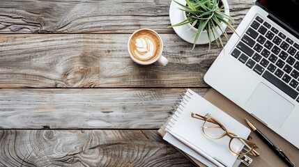 Wall Mural - Work from home concept Office desk setup with a laptop blank notepad coffee cup and pen on a wooden table Top view with copy space in a flat lay style