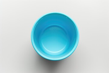 Sticker - A blue ceramic bowl sits alone on a table