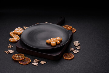 Wall Mural - Beautiful festive Christmas composition of an empty plate, gingerbreads and star anise