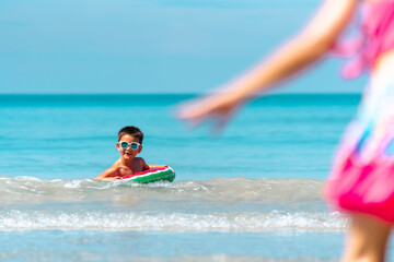 Wall Mural - Group of Children kid enjoy and fun outdoor lifestyle travel ocean on summer beach holiday vacation. Diversity child boy and girl friends running on the beach and playing sea water at tropical island.