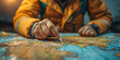 © khonkangrua - Close-up of a hand pointing at a map, emphasizing travel planning and navigation in a warm, indoor setting.